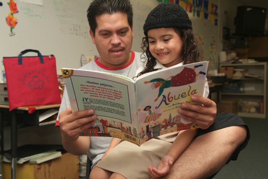 Father and daughter reading Abuela